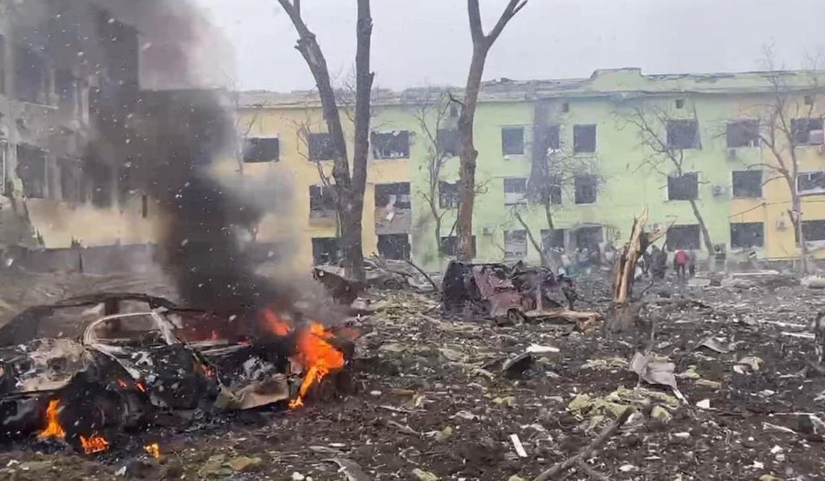 A view shows cars and a building of a hospital destroyed by an aviation strike